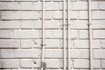 White wall and electrical conduit pipes