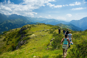 Group of tourists is walking in Caucasian mountains 