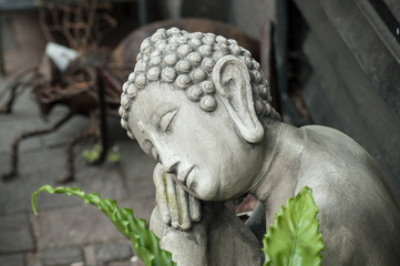 closeup of buddha statue at florist in the street