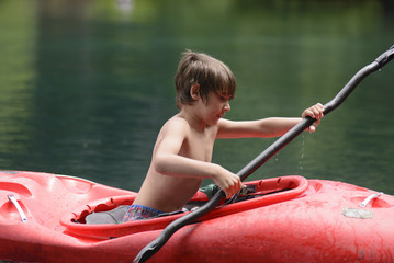 Boy enjoying the summer in his kayak. 