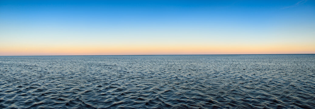 Fototapeta Panorama of sea waves on the background of dawn