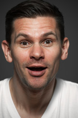 Close-up portrait of positive caucasian man on gray background