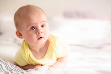 Cute baby girl looking right from camera. Copy space