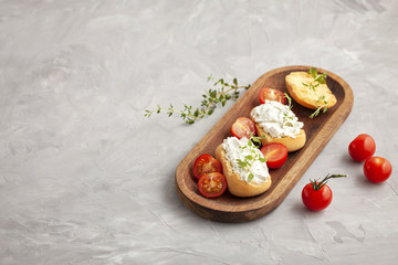 Italian appetizer toasted bread bruschetta with cream chease and tomatoes. Delicious and healthy meal, copy space