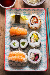Selection of sushi on the plate. Nigiri king prawn. Maki with pickled cucumber. Nigiri salmon, Nigiri avocado. California roll.