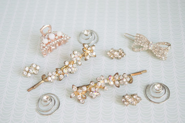 Girl accessories near the casket. Hairpins, earrings, rings are the treasures of a little girl. Children's costume jewelery