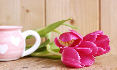 Spring is coming.Beautiful pink tulips on wooden background. Top view, copy space. Space for text, copy, lettering. Postcard template. Concept spring flowers.