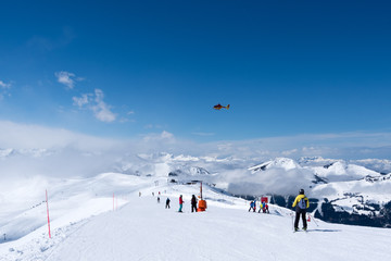 Mountain rescue helicopter above Alps, Kitzbuhel, Austria