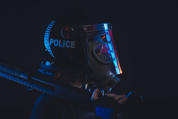 Protection, Special unit policeman in a gas mask and shield, isolated on black