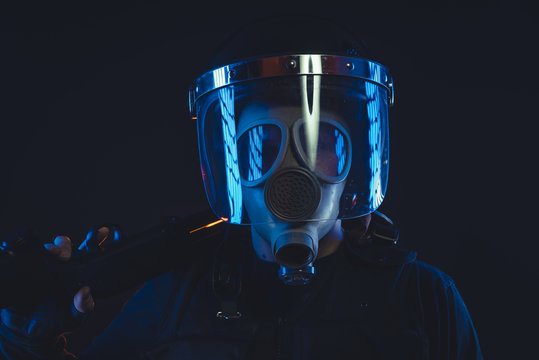 Soldier, Special unit policeman in a gas mask and shield, isolated on black
