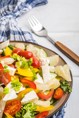 Salad with cheese and fresh vegetables.