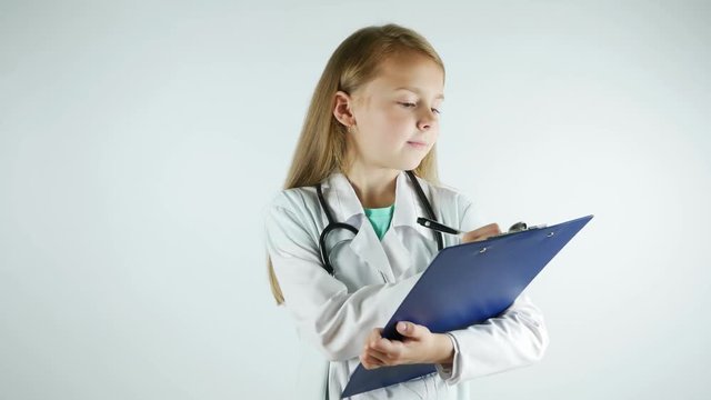 Lovely little girl shows serious doctor, writes medical prescription. 