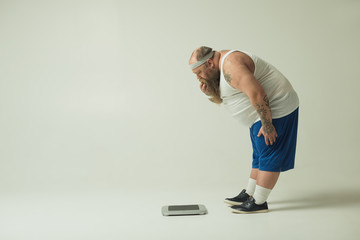 Man staring at a scale