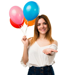 Beautiful young girl holding a balloon and holding something