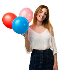 Happy beautiful young girl holding a balloon