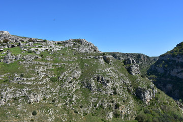Italy, Basilicata, Matera, city of stones, Unesco heritage, capital of European culture 2019. Hill with ancient caves in front of the city, on the river gravina