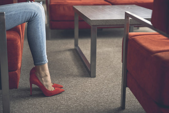 Close Up Woman Feet. She Sitting On Cozy Couch At Table Indoor. Rest Concept