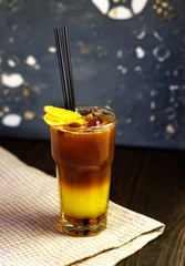 cold orange coffee in glass Cup on wooden background