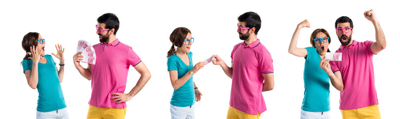 Couple in colorful clothes taking a lot of money