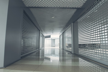 Interior of dark hallway in business center with light entrance at end of it