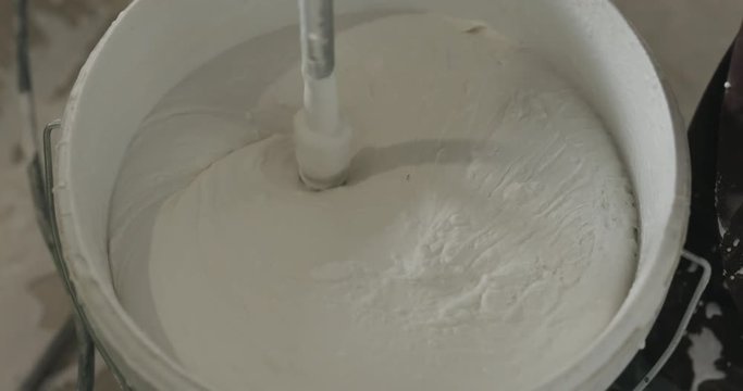 slow motion stirring putty in the bucket