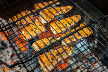 Grilled steaks a on open grill on back yard