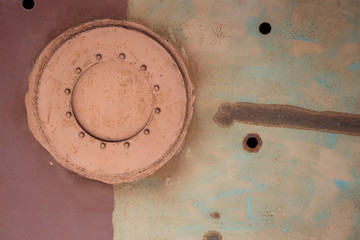 manhole and hole in rusty sheet