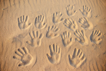 lots of hand prints on the sand
