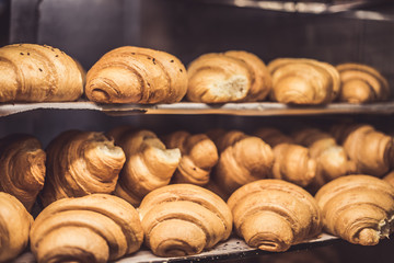 A lot of fresh homemade croissants Sold in a small bakery.