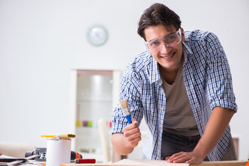 Young man in woodworking hobby concept