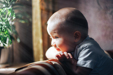 happy baby boy looking at window waiting
