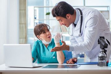 Fototapeta premium Doctor angry at his assistant due to medical error