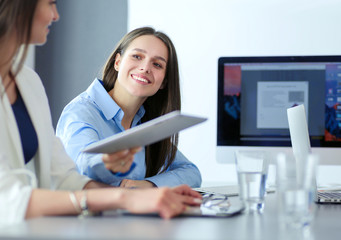 Attractive business woman working on laptop at office. Business people