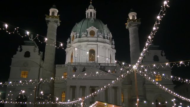 Tilt down of Karlskirche and Karlsplatz Christmas market