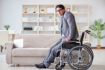 Fototapeta na wymiar Dsabled businessman on wheelchair working home
