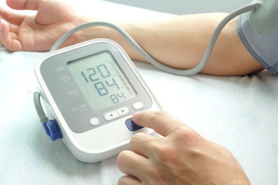 A man check blood pressure monitor and heart rate monitor with digital pressure gauge. Health concept