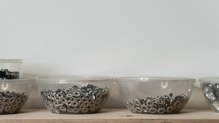 Rivet fasteners in plastic containers. Tanner's workshop