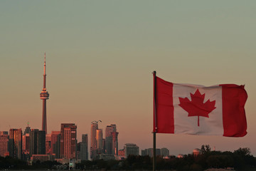 Canada Flag and Toronto CN Tower at the sunset in summer