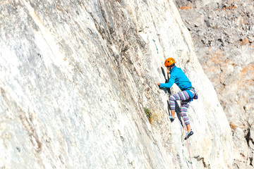 Woman in helmet on the rock.