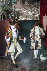 Actors in Steam punk masks and antique costumes indoor.