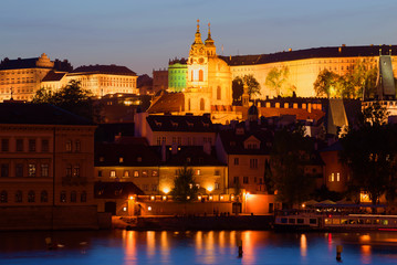 View of the bell tower and the dome of St. Mikulas Cathedral on the evening of April. Prague, Czech Republic