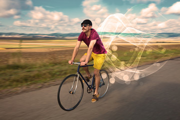 Fototapeta premium Gorgeous biker in the nature going somewhere with ethereal concept