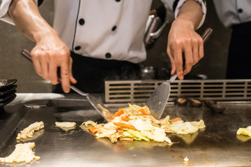 Abstract Chef is cooking Japanese style at the restaurant.