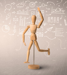 Wooden mannequin posed in front of a greyish background with white scribbled data around him