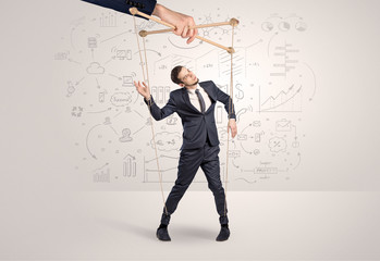 Little businessman controlled from above like a puppet concept
