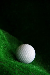 golf ball on the green with black background stock photo