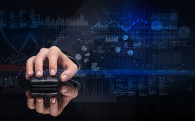Hand using wireless mouse with financial concept on dark background
