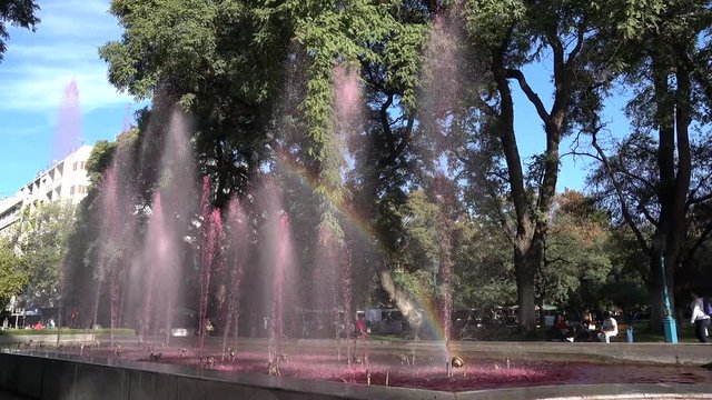 Wine fountain with rainbow. The fountains are tinted pink to look like giant pools of inviting red, Plaza de Independence of Mendoza, the city of wine, Argentina, 4K