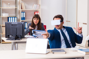 Employee with virtual reality glasses in office