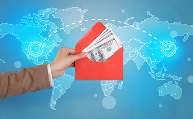 Female hand holding coloured and white envelope with blue map on the background

